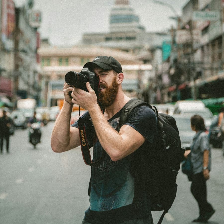 A man looking through a camera