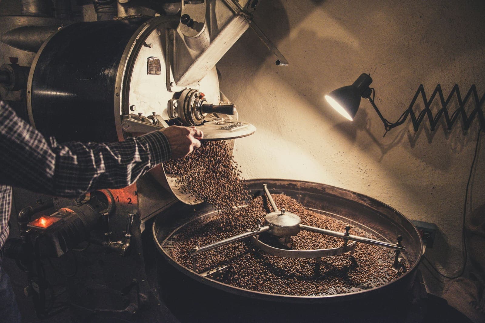 Pouring green beans into the roaster
