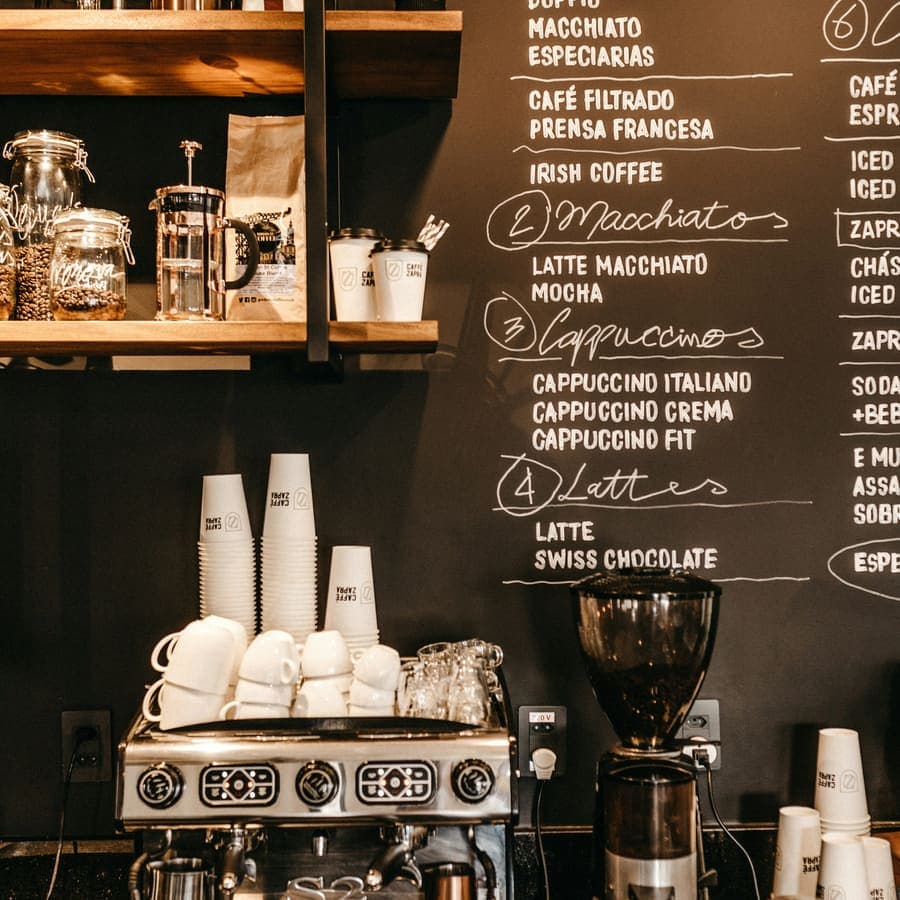 The espresso machine under the chalkboard