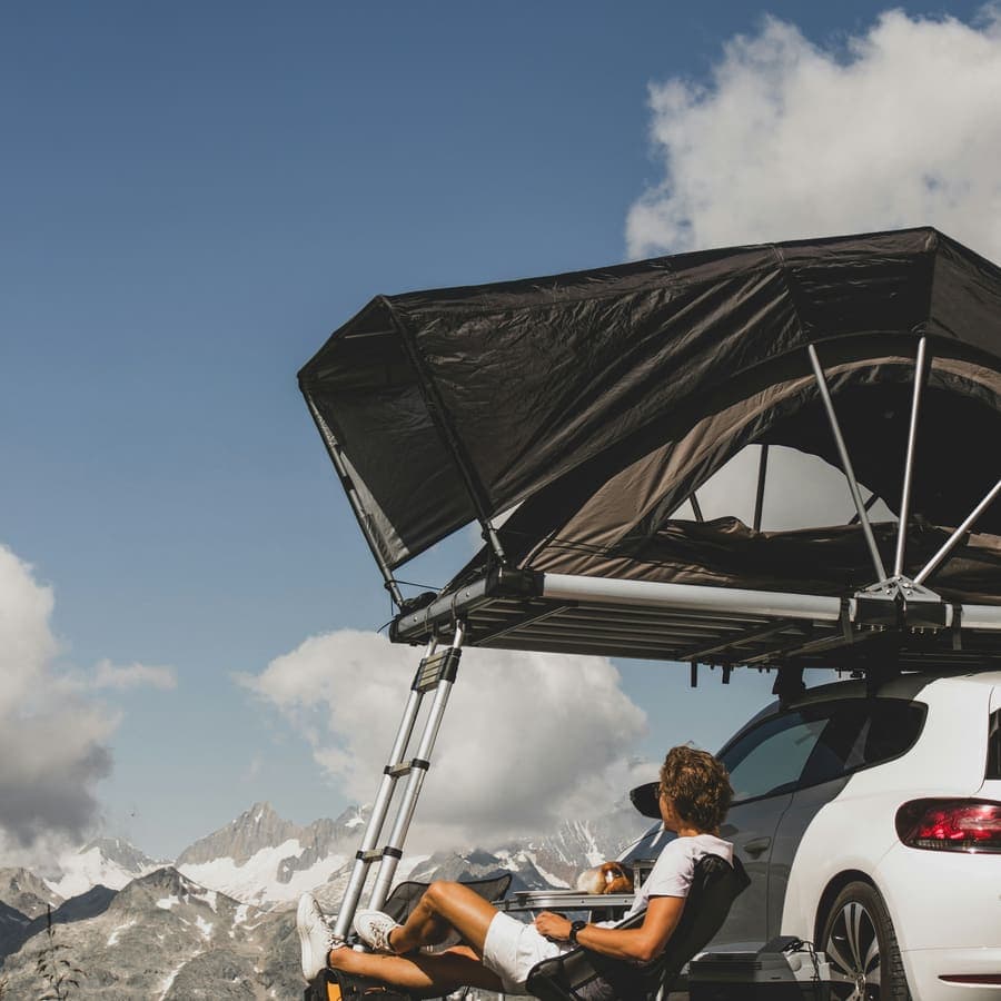 Climbing out of a rooftop tent at first light