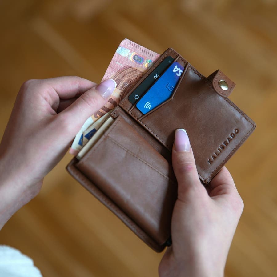 A hand holding a card wallet