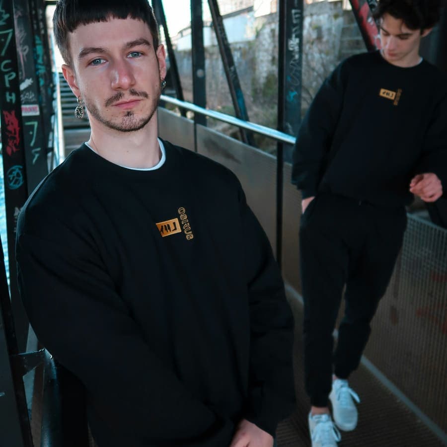 Two in black on a footbridge