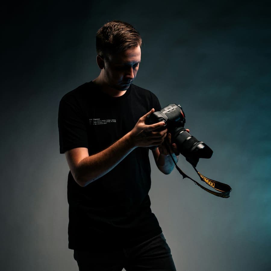 A photographer in a black t-shirt