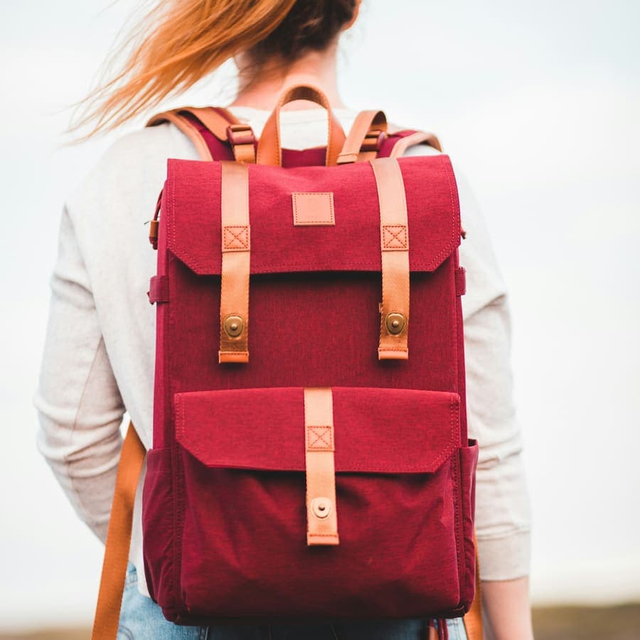 A woman wearing a red and black backpack