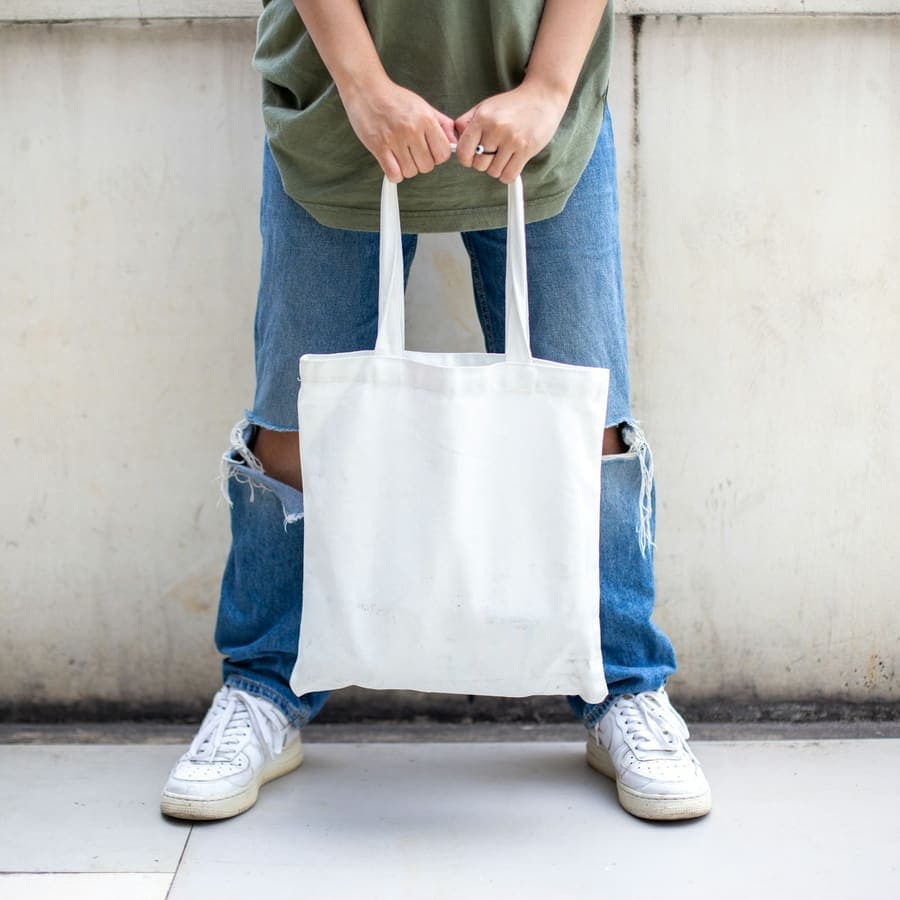A white tote held at the hip
