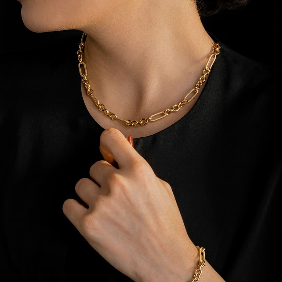 A gold chain bracelet on a wrist