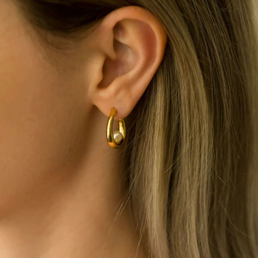 A gold hoop, worn