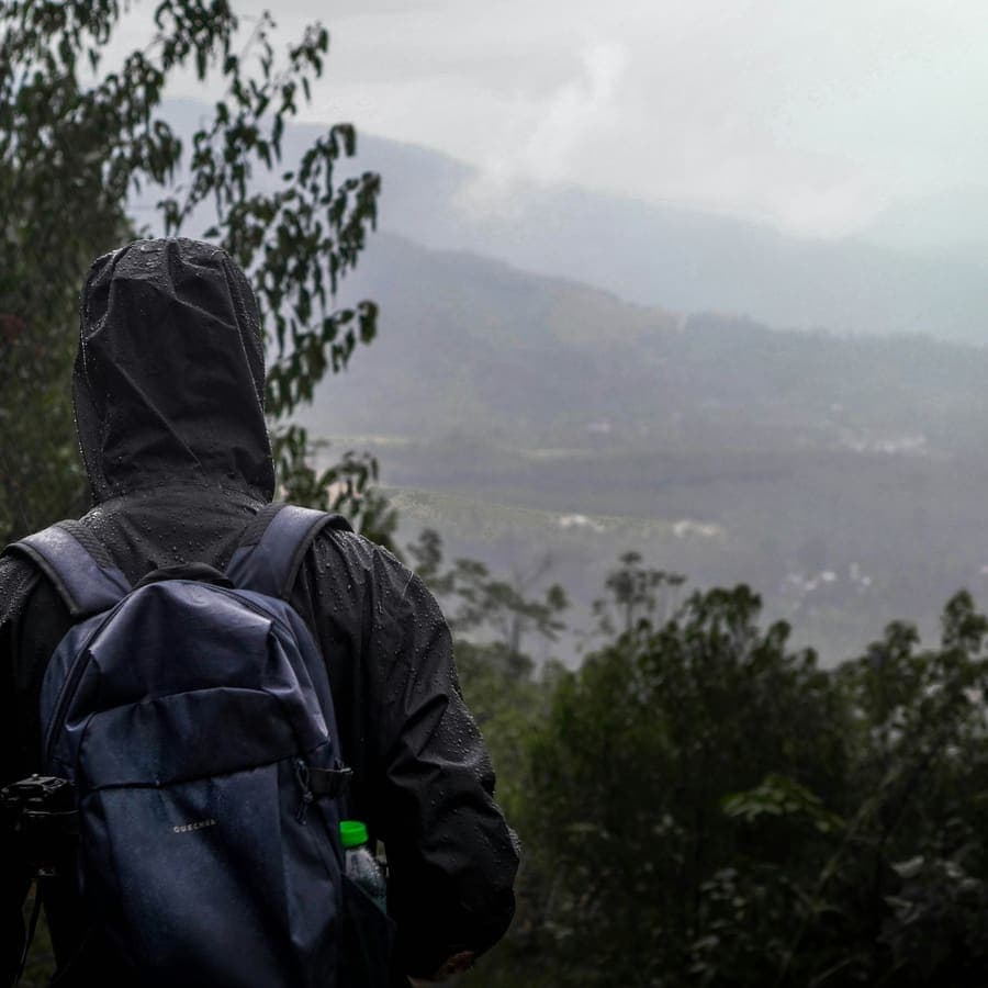 A person with a backpack walking up a hill