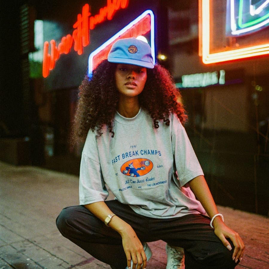 Crouched under a neon sign