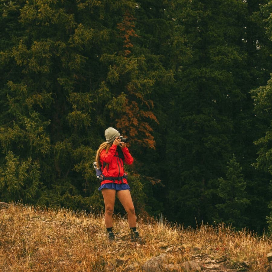 A woman hiking through dense forest