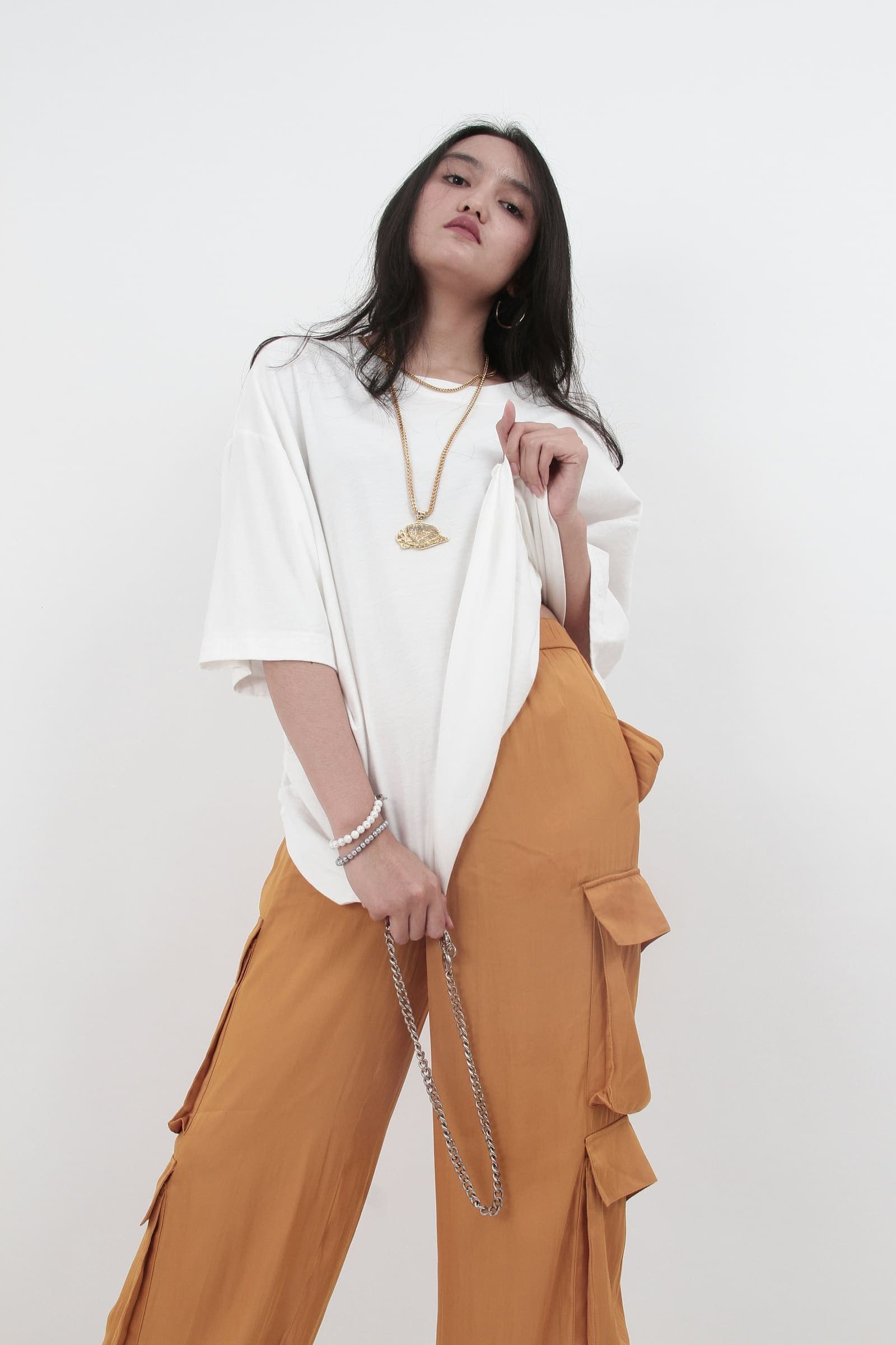 An oversized white tee over wide trousers
