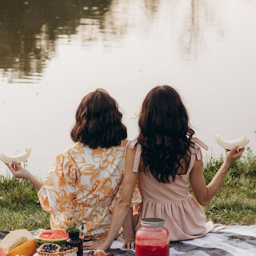 Two friends laughing by the water
