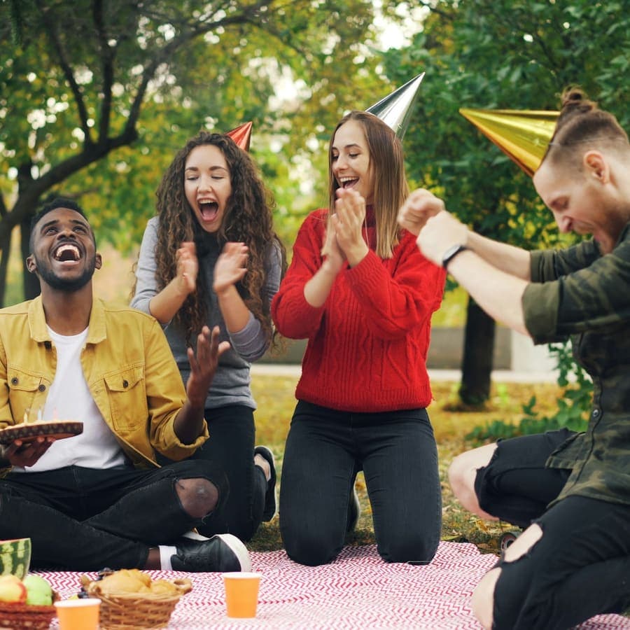 Friends celebrating a birthday outdoors
